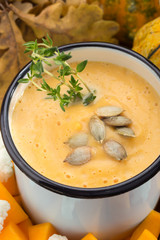 Cream soup with cauliflower. Pumpkin and cauliflower soup. Homemade. Cream soup in a mug. Cream soup with vegetables. Sunny picture. Autumn. Pumpkin, Cauliflower. Vegetable soup. Free space for text.