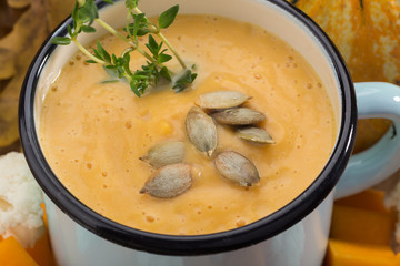 Cream soup with cauliflower. Pumpkin and cauliflower soup. Homemade. Cream soup in a mug. Cream soup with vegetables. Sunny picture. Autumn. Pumpkin, Cauliflower. Vegetable soup. Free space for text.