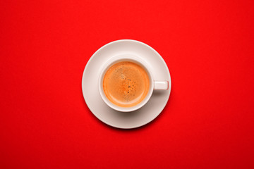 Black coffee in a cup on a red background