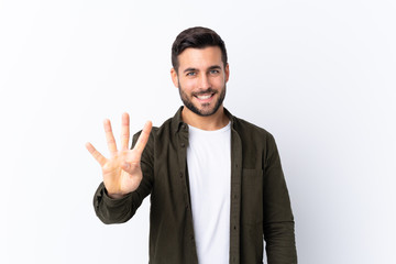 Young handsome man with beard over isolated white background happy and counting four with fingers