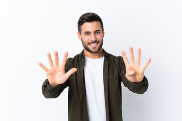 Young handsome man with beard over isolated white background counting nine with fingers