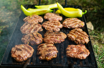 Summer barbecue. Fresh burgers on grill