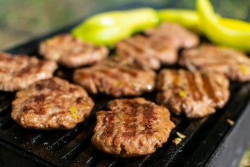 Summer barbecue. Fresh burgers on grill