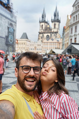 Fototapeta na wymiar Man and woman walking in city streets on vacation tourism and making selfie.