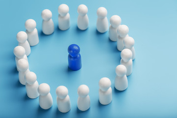 A team of white people stands around and listens to the leader's blue leader. The concept of the leader of the business team.