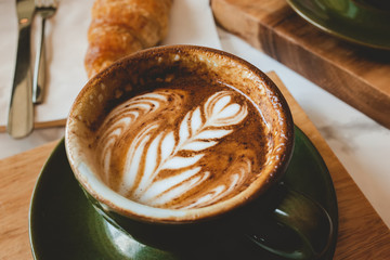 Hot coffee cappuccino in morning worm lighting.