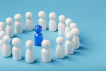 A team of white people stands around and listens to the leader's blue leader. The concept of the leader of the business team.