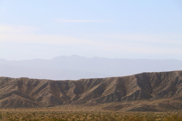 a hazy distance desert mountain range