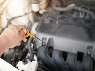 hand of a man opening the bonnet To check general car conditions, Engine, oil, radiator.