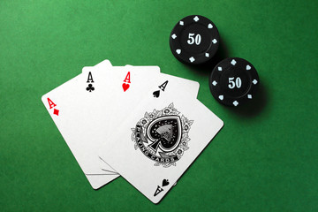 playing cards, four aces on a green background
