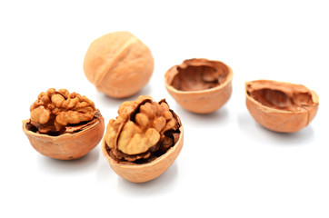 Peeled walnuts on a white indoor background