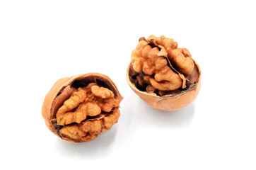 Peeled walnuts on a white indoor background
