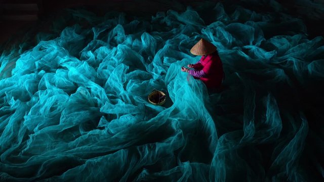 women repairing fishing nets in a village at Xiapu, China. Xiapu is a major fishermen's port and has an important seafood farming industry in CHINA., Lockdown.