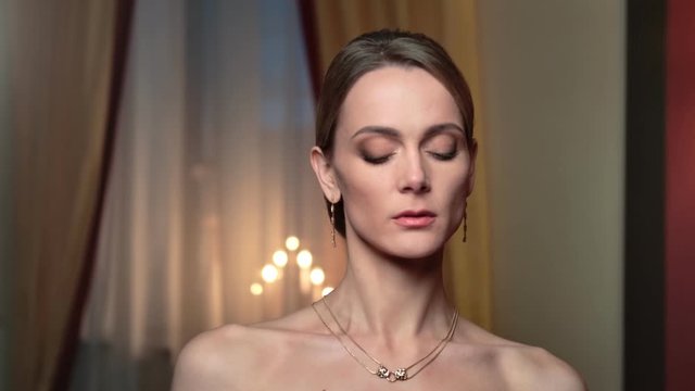 Seductive fashion woman in golden necklace and earrings walking. Close up shot on 4k RED camera