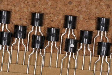 Electronic components, Small Signal Transistors Taped (Cork board textured background)