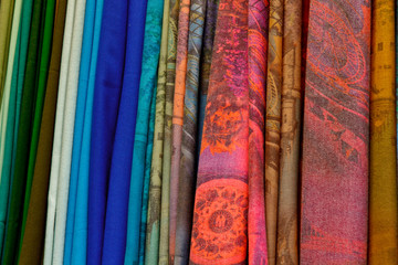 Blurry, not sharp sharpness Texture, background, pattern. Silk fabric is transparent, yellow-pink green in blue. Abstract soft chiffon texture background.