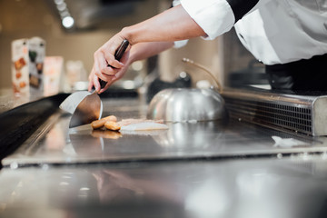 Hand of man take cooking of meat with vegetable grill, Chef cooking wagyu beef in Japanese teppanyaki restaurant