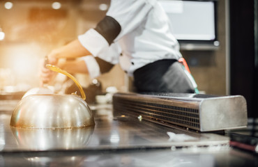 Hand of man take cooking of meat with vegetable grill, Chef cooking wagyu beef in Japanese teppanyaki restaurant