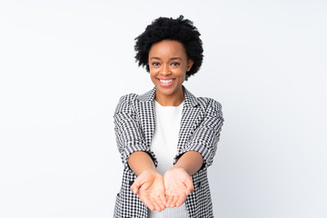 African american woman with blazer over isolated white background holding copyspace imaginary on...