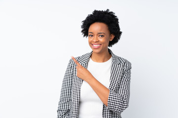 African american woman with blazer over isolated white background pointing to the side to present a product