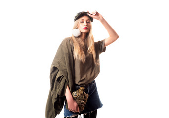 Fototapeta na wymiar Attractive blonde model wearing military english scottish. Khaki hat, accessories and water bottle looking confident and cheeky over white background.