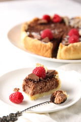 Chocolate cake with cottage cheese and raspberries on a light background. Background image, copy space