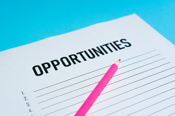 Obraz premium Opportunity text on white paper with list lines and pink pen, concept.