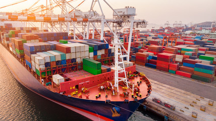 crane loanding cargo container to container ship in the international terminal yard port  concept...