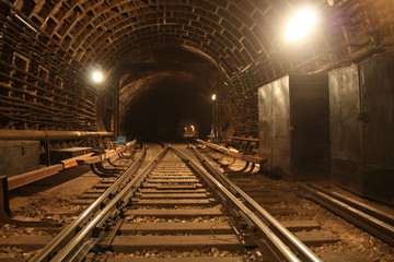 Brightly lit railway fork in the road ways in the subway