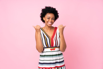 African american woman over isolated pink background with thumbs up gesture and smiling