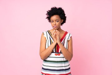 African american woman over isolated pink background scheming something