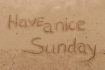 Handwriting  words "Have a nice Sunday." on sand of beach.