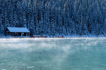 Lake Louise with morning fog and the boat house