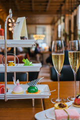 afternoon tea and glasses of champagne on table