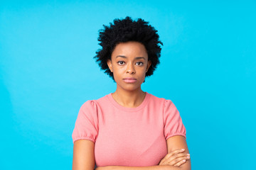 African american woman over isolated blue background keeping arms crossed