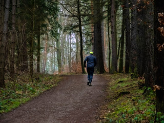 Obraz premium Man goes in for sports in the forest.