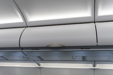 Interior of airplane with sitting passengers.