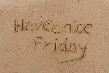 Handwriting  words "Have a nice Friday." on sand of beach.
