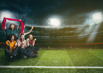 Soccer fans in the middle of the action during a night game at the stadium