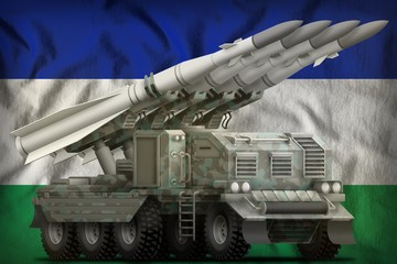 tactical short range ballistic missile with arctic camouflage on the Lesotho national flag background. 3d Illustration