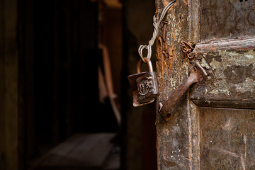 Chongqing, China - March 21, 2018: Old door with a lock in an abandoned house in the Chinese city...