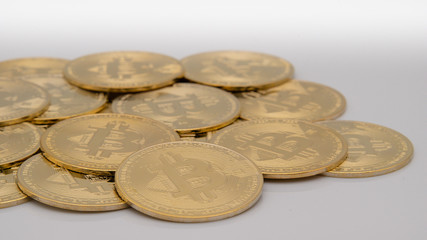 many Bitcoins BTC coins on white background