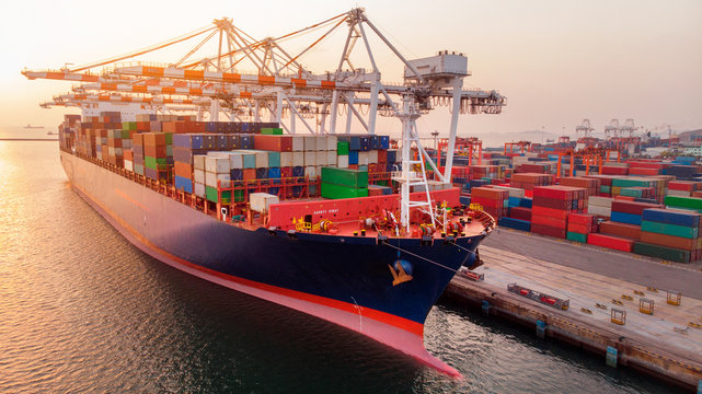 Crane Loanding Cargo Container To Container Ship In The International Terminal Yard Port  Concept Freight Shipping By Ship At Sunrise . Crane Working In The Sea   Forwarder Mast