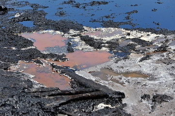 Deposits of ozocerite on the surface of the soil near the old oil wells,selective focus.