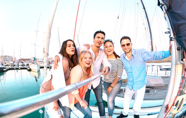 Friends group taking selfie pic with stick on luxury sailing boat party trip - Friendship concept...