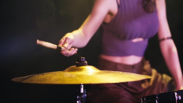 cropped view of woman rehearsing on drums