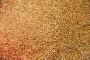 Nature background of cracked dry lands. Natural texture of soil with cracks. Broken clay surface of barren dryland wasteland close-up. Full frame to terrain with arid climate. Lifeless desert on earth
