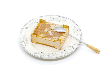 Honeycomb in a wooden frame on a plate 