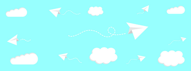 Paper planes fly in sky against white clouds