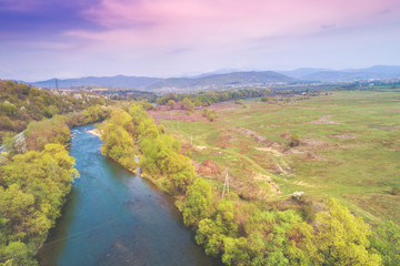 Naklejka premium Panoramic view of the river in a mountain valley in early spring. View from above